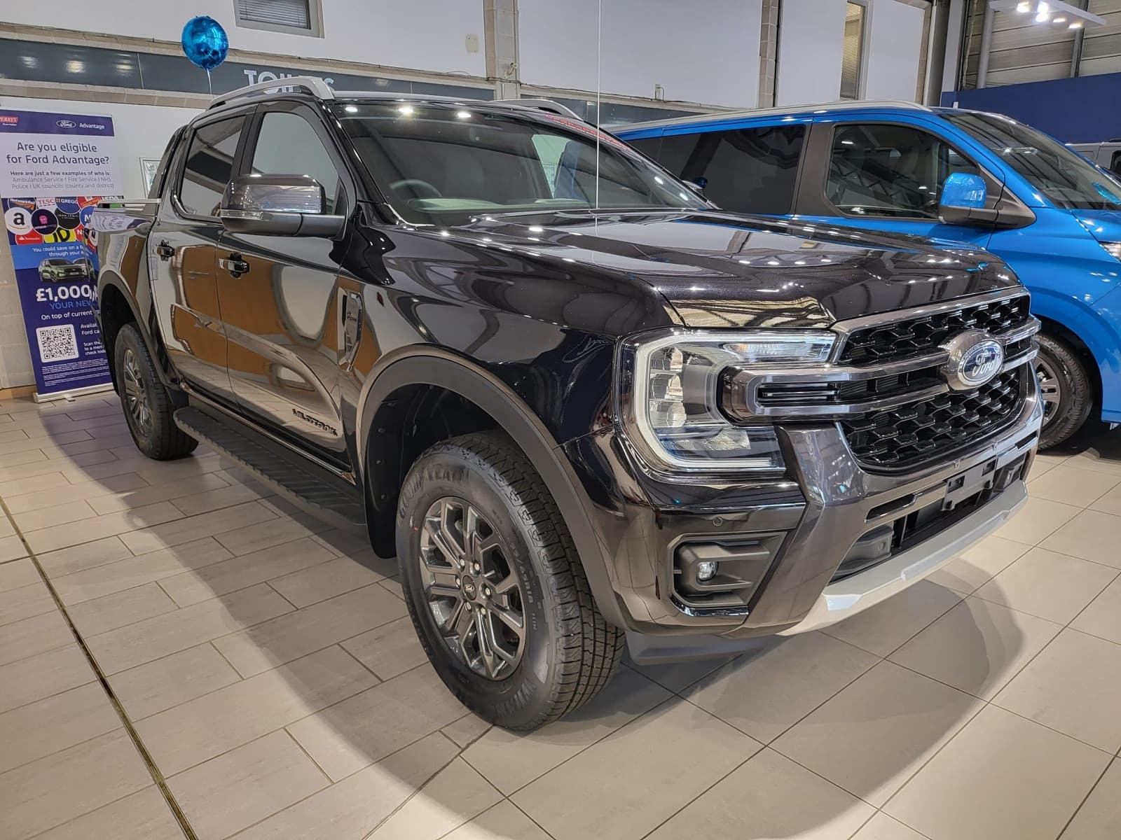 Black pickup truck, front three-quarter view