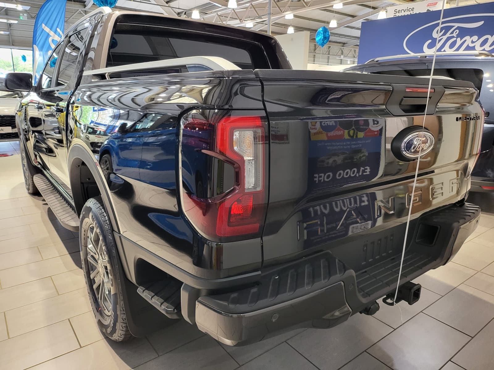 Black pickup truck, rear three-quarter view