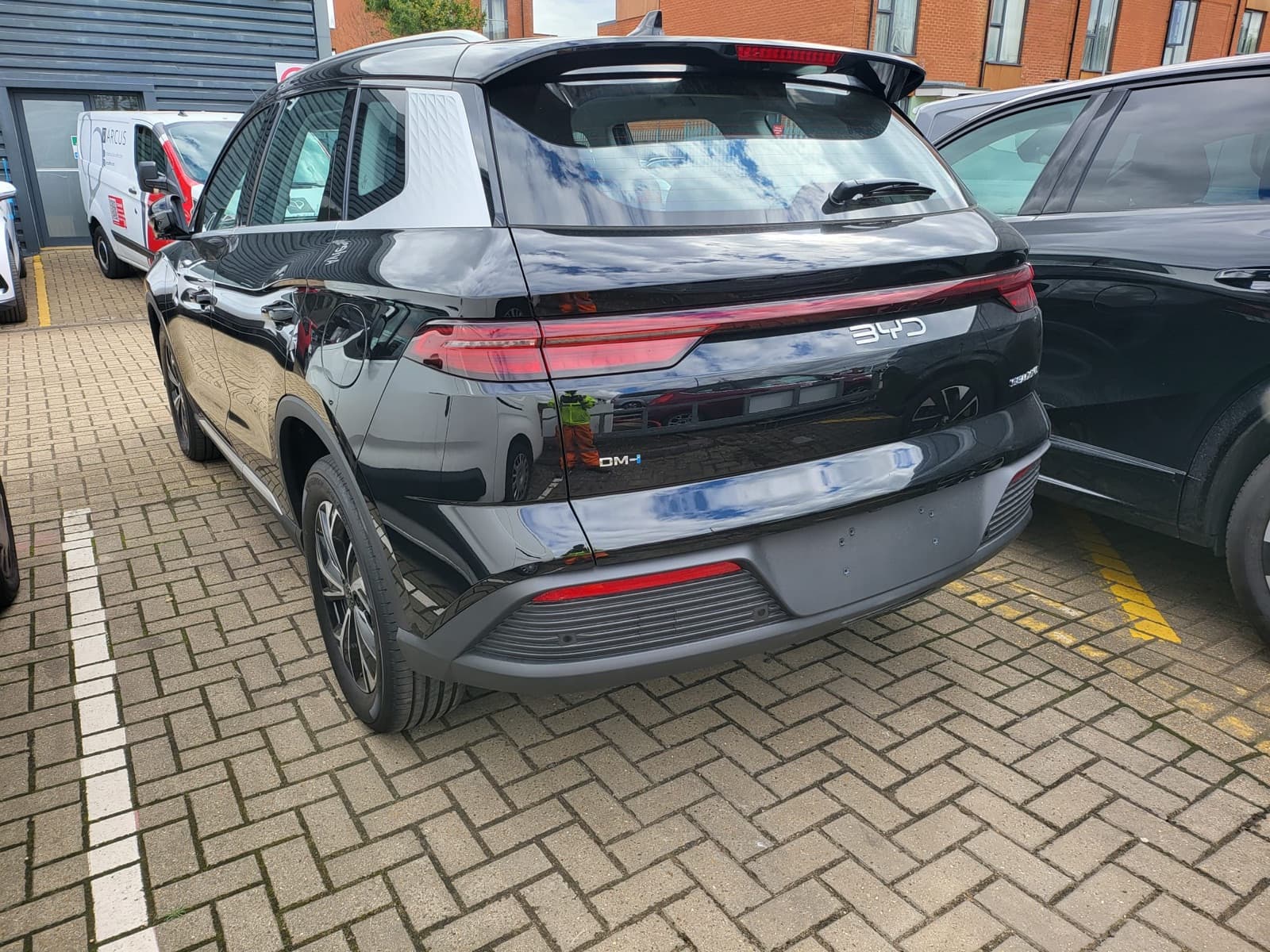 Black compact SUV, rear three-quarter view